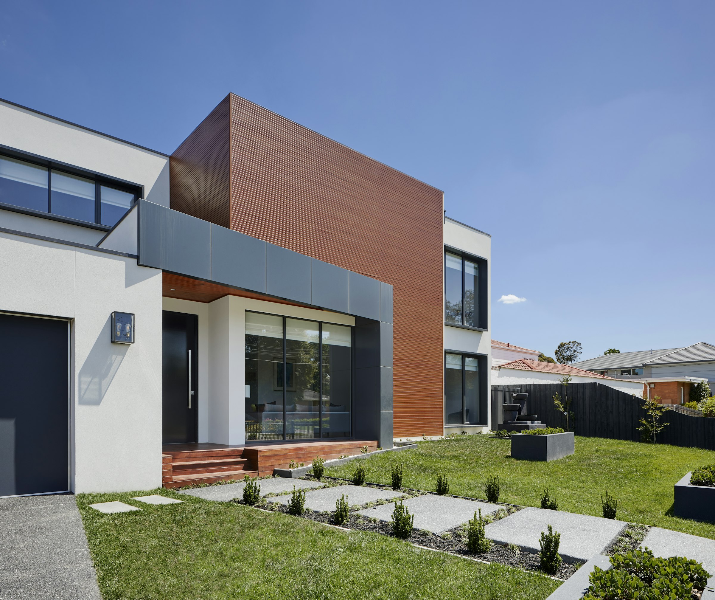Contemporary residence with timber and white facade