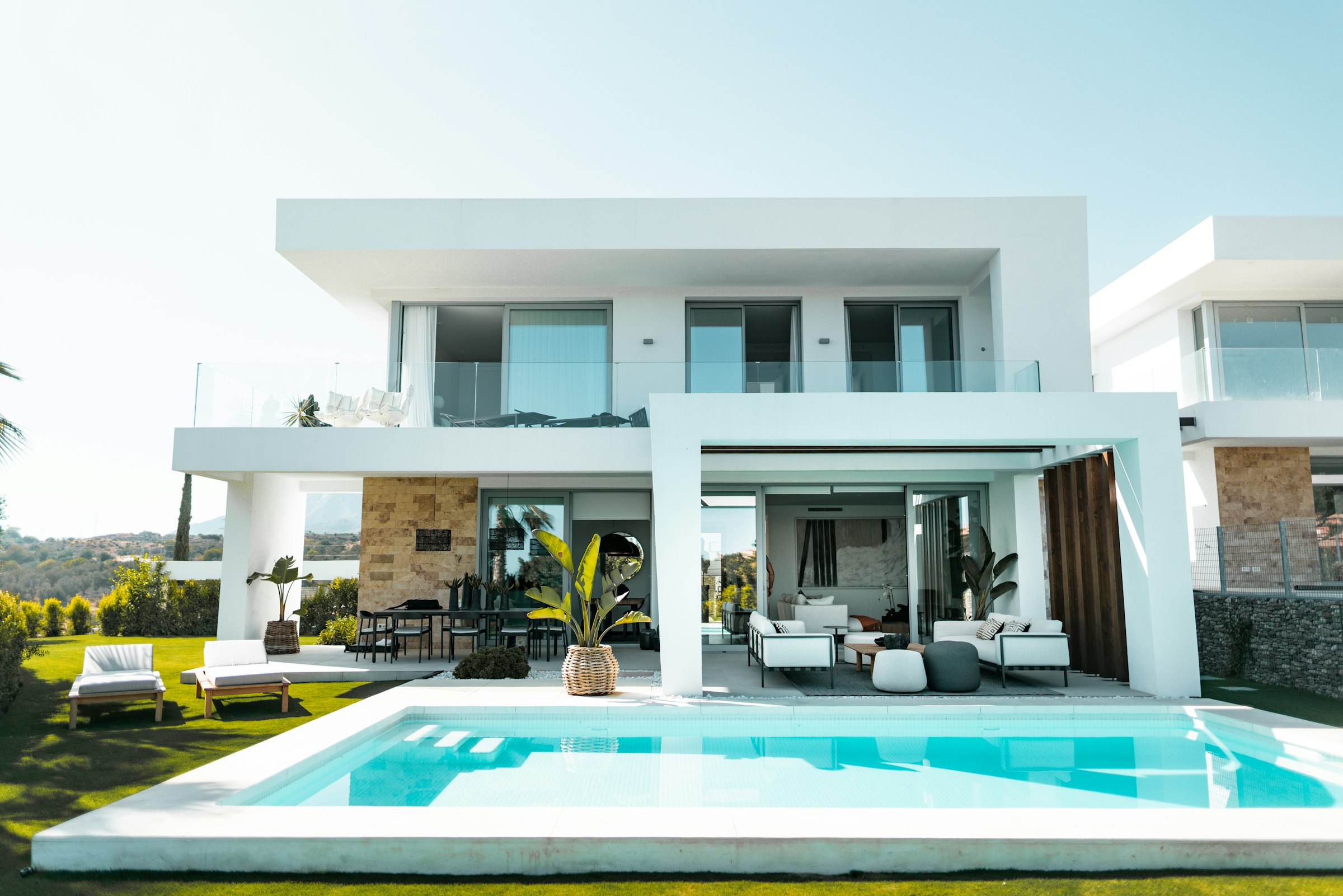 White modern villa with pool and loungers
